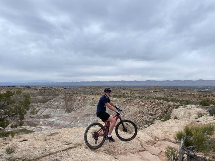AWS Senior Solutions Architect, Michael Mumma on a mountain bike in a rocky, desert setting