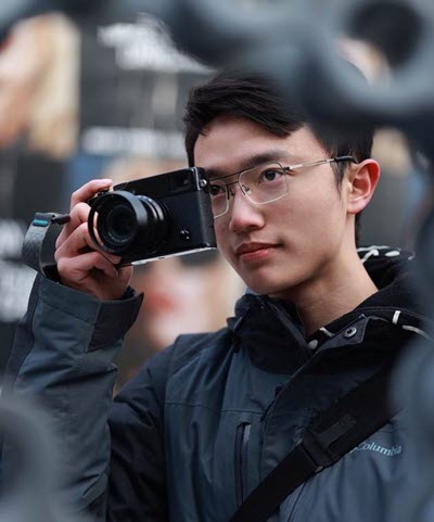 Matthew Zeng taking a photo with a camera