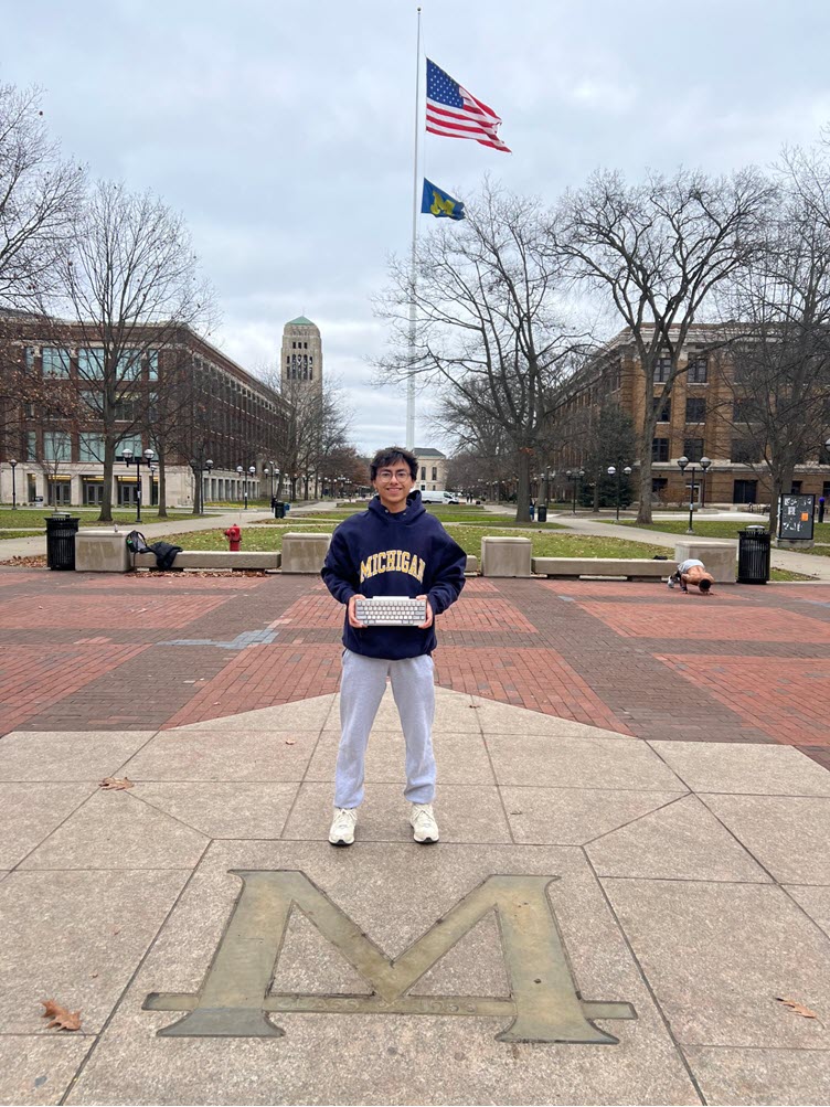 University student standing in U Michigan quad with an HHKB keyboard.
