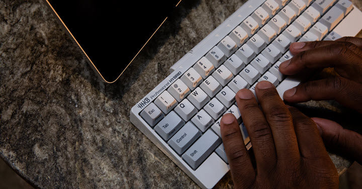 Hands on an HHKB keyboard. 