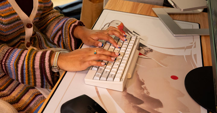 Woman typing on an HHKB keyboard. 